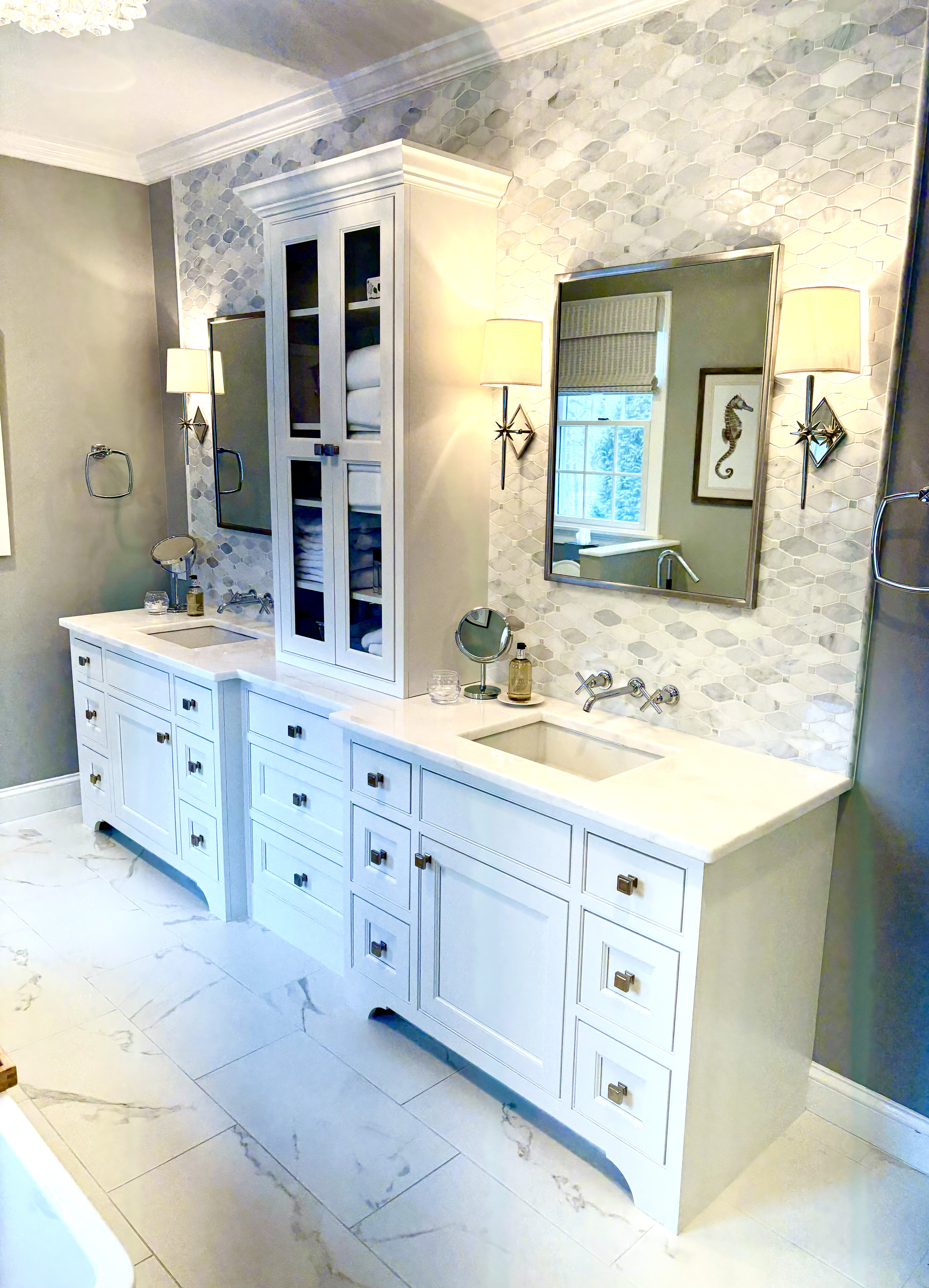 White cabinets, grey tile backsplash and glass linen cabinet doors