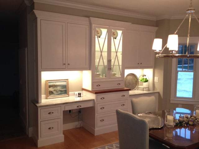 White built-in hutch and desk with glass cabinet doors