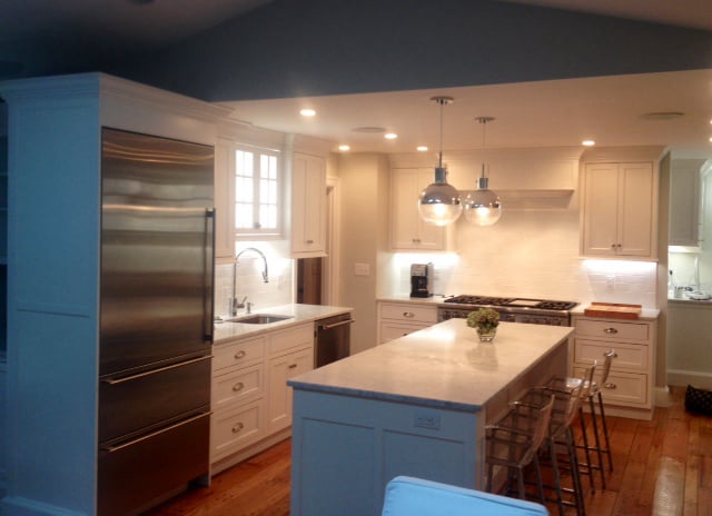 White oak kitchen island with pendant lighting and marble countertop